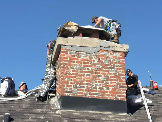 Seven Hills Chimney Sweep installing a custom chimney crown in Seven Hills, OH