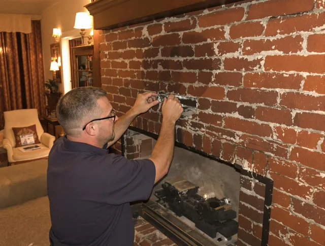 Seven Hills Chimney Sweep expert fixing a fireplace in Seven Hills, OH